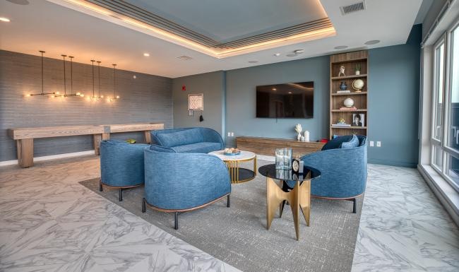 Enjoy our resident-only features a room with blue chairs and a table